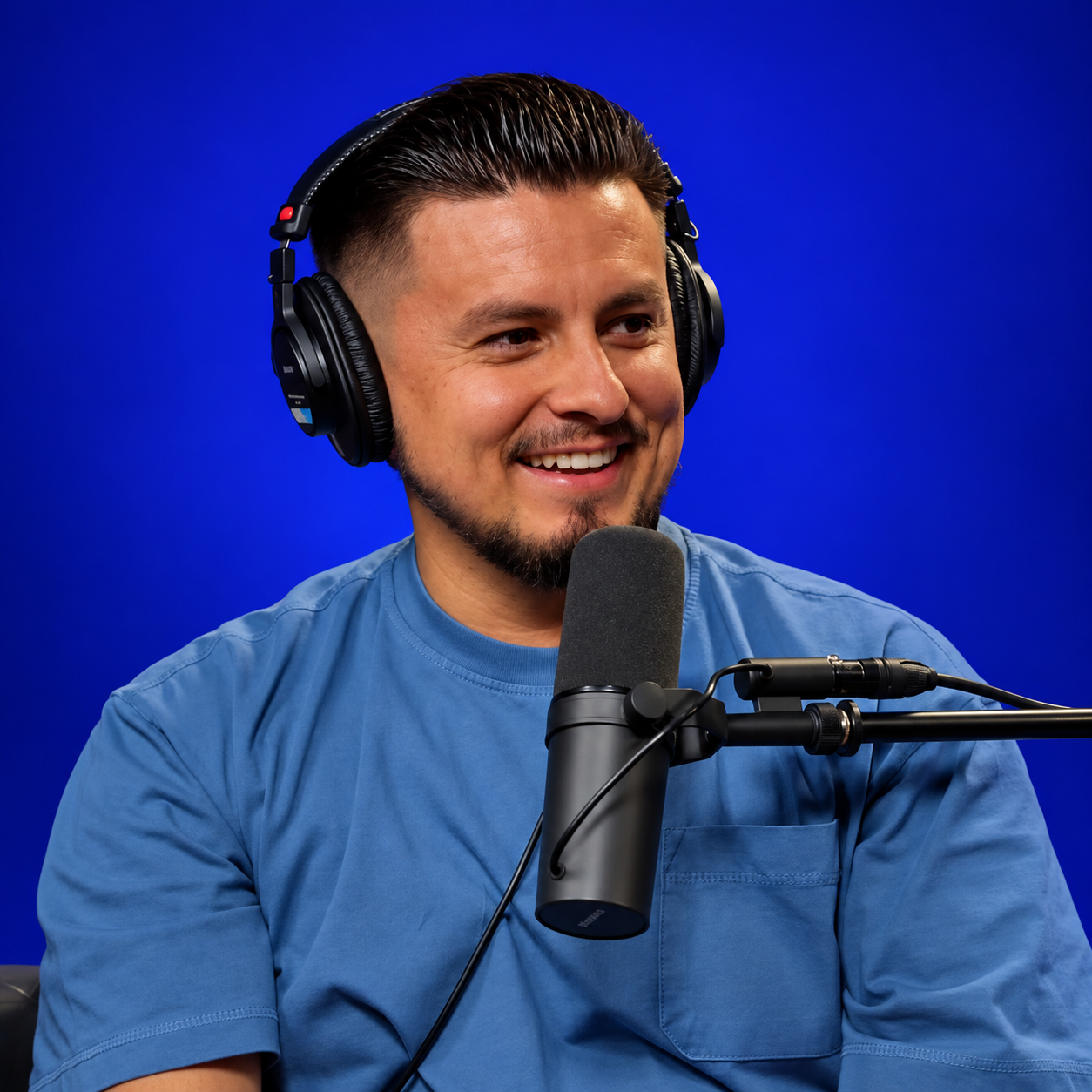 AJ Morales, host of Solafide Podcast, wearing headphones and speaking into a microphone